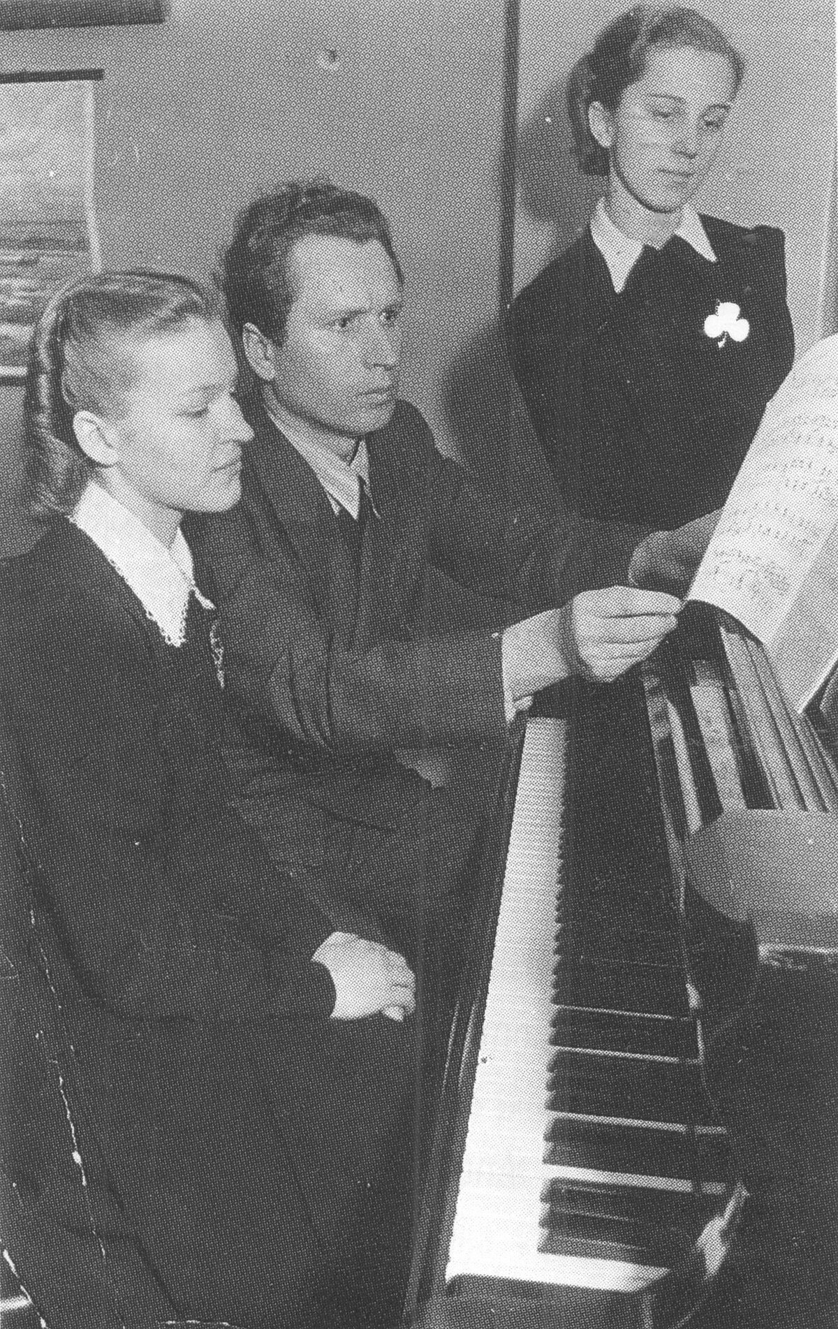 Ella Detlova (stāv) ar klavieru skolotāju Arvīdu Žilinski, 1939. gads. No A. Mellupes grāmatas “Atvērtās durvis: Rīgas pirmā ģimnāzija portretos un notikumos”. Ella Detlova (stāv) ar klavieru skolotāju Arvīdu Žilinski, 1939. gads. No A. Mellupes grāmatas “Atvērtās durvis: Rīgas pirmā ģimnāzija portretos un notikumos”.